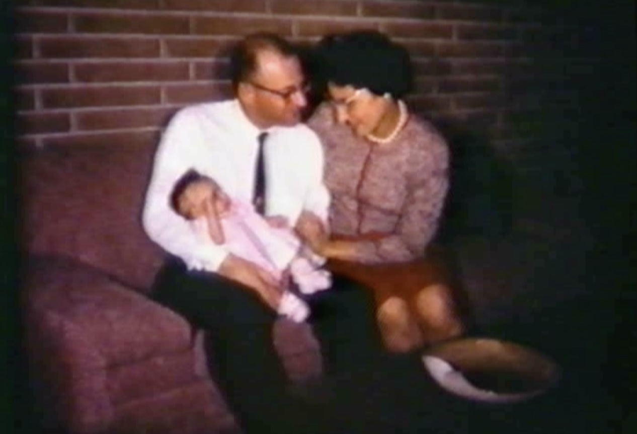 husband and wife with baby